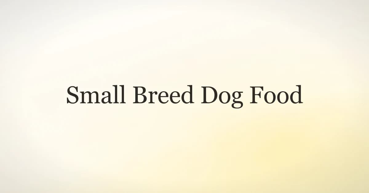 A small breed dog eating small kibble from a bowl on a kitchen floor